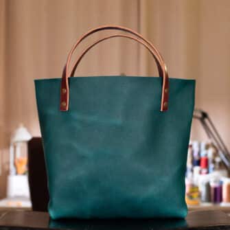 Alternative view of SoRetro Verdura Perfect FYG Leather Crossbody Tote – Cacciatore di Abisso with Exclusivo Penobscot Vineyard on Tropical Beach Blue Webbing – Bronze Hardware