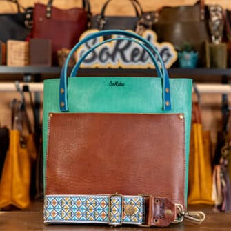 SoRetro Verdura Two Tone Perfect FYG Leather Crossbody Tote – Soia Fresca and Aglio Bruciato with Isosceles Explosion on Anchor Bay Beach Waves Webbing – Bronze Hardware