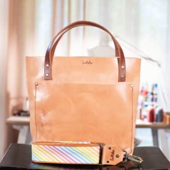 SoRetro Perfect FYG Leather Crossbody Tote – Sweet Onion with Today's Rainbow on Cinnamon Cotton Webbing – Bronze Hardware