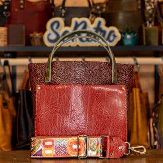 SoRetro Mini+ FYG Leather Crossbody Tote – Novarupta with Sierra Cotta with Exclusivo Little House on the Prairie by the Sea on Sienna Cotton Webbing – Bronze Hardware